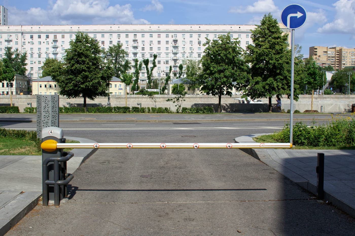 Boom barrier controlling vehicle entry at a building entrance
